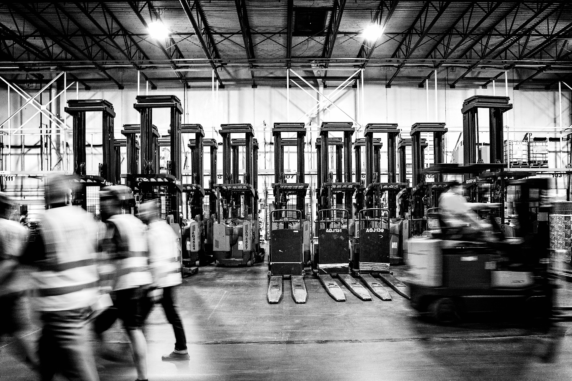 Frontline supervisor coaching team members in a distribution warehouse