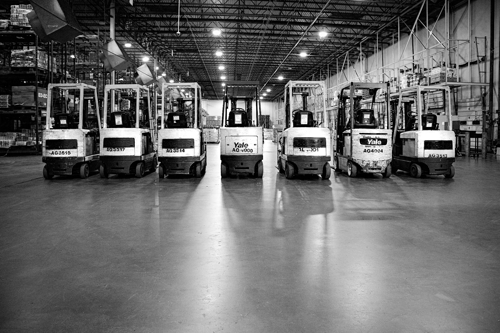 Warehouse supervisor leading a team meeting on the distribution floor at golden hour